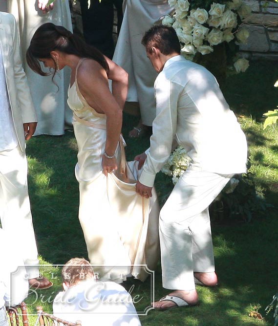 Eddie helped his new wife with her Hanna Hartnell wedding dress after posing for wedding pictures